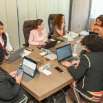 Sandra Ribeiro e outras delegadas reunidas à mesa.